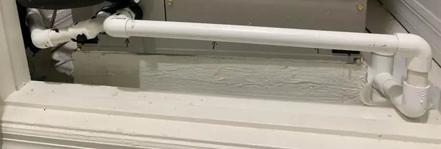 Air handler with a PVC condensate drain line in a Brooksville utility closet