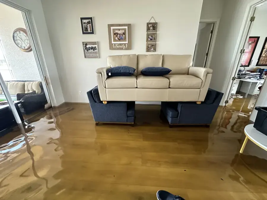 Storm floodwater across the living room floor of a Brooksville home